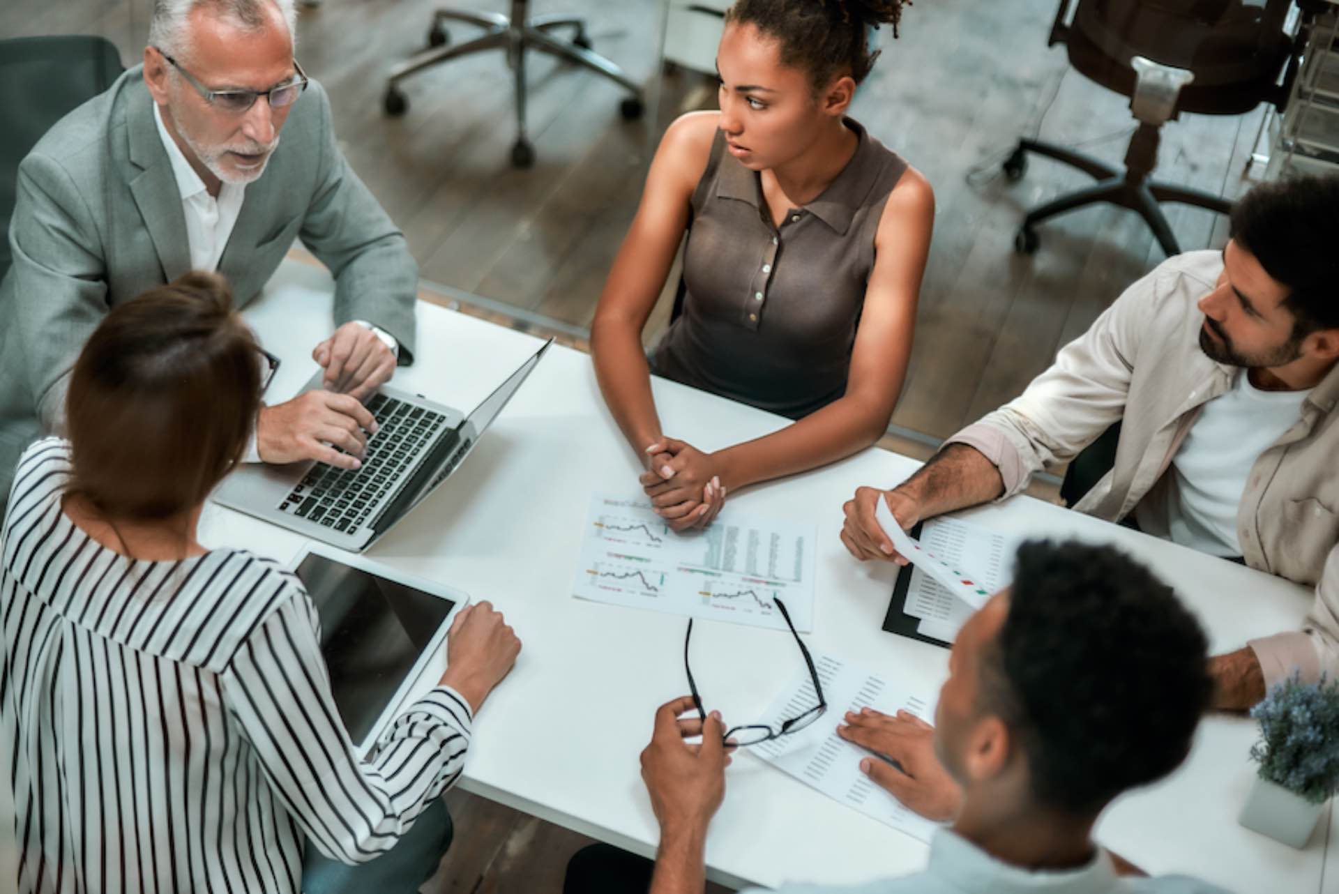 top-view-of-multicultural-team-discussing-business-2022-03-31-07-01-46-utc-2.jpg